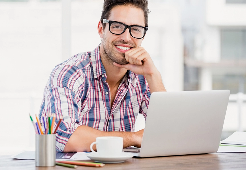 Entrepreneur travaillant sur son ordinateur préparant un projet de franchise pressing 5asec avec un modèle d’investissement accessible et accompagné.